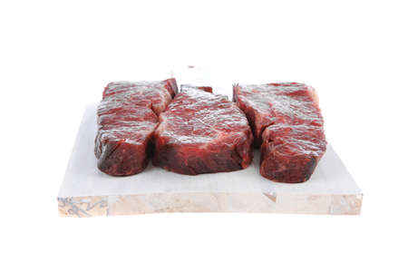 three fresh raw marble beef meat sirloin porterhouse steak on light wood cut board isolated on white backgroundの写真素材