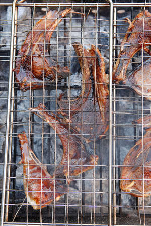 fresh raw lamb ribs on bbq grid grill cooked over charcoalの写真素材
