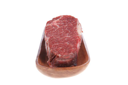 three fresh raw marble beef meat sirloin porterhouse steak on long wooden tray isolated on white backgroundの写真素材