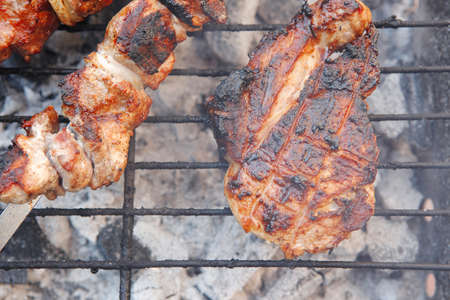 fresh beef meat kebab on barbecue grid grill cooked over burned churcoalの写真素材