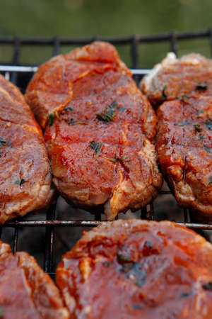 fresh beef meat fillet steak on barbecue grill grid cooked over burned charcoal readyの写真素材