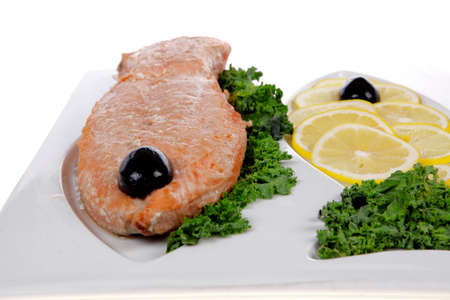 healthy food - fresh roast red fish salmon with kale lemon and black olives on plate isolated on white background space for textの写真素材