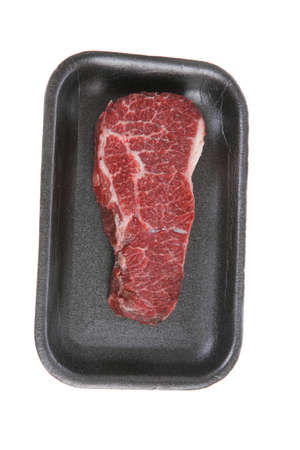 fresh raw marble beef meat steak on black plastic market tray isolated on white backgroundの写真素材