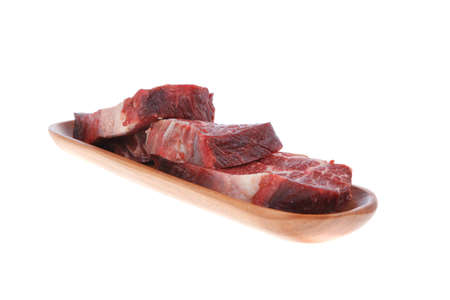 three fresh raw marble beef meat sirloin porterhouse steak on long wooden tray isolated on white backgroundの写真素材