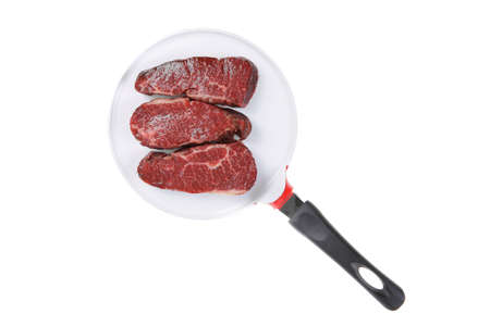 three fresh raw marble beef meat sirloin porterhouse steak on big ceramic cooking pan isolated on white backgroundの写真素材