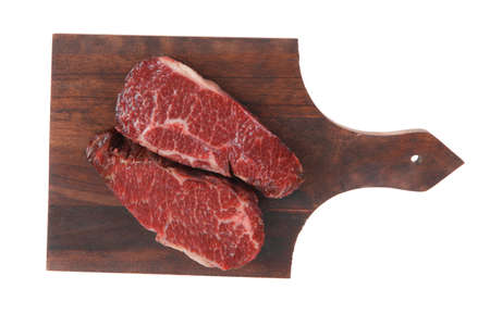 two fresh raw marble beef meat sirloin porterhouse steak on dark wood cut board isolated on white backgroundの写真素材