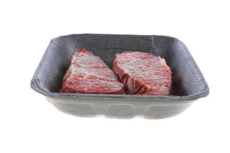 two fresh raw marble beef meat sirloin porterhouse steak on black market plastic tray isolated on white backgroundの写真素材