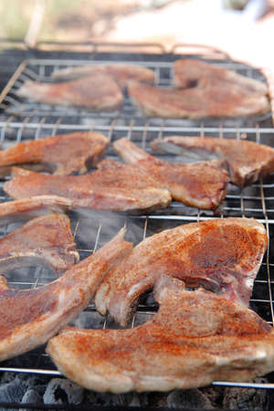 fresh raw lamb ribs on bbq grid grill cooked over charcoalの写真素材