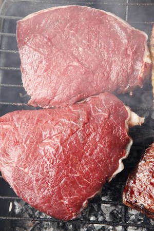 grilled roast meats beef lamb fillet ribs on bbq grid over charcoalの写真素材