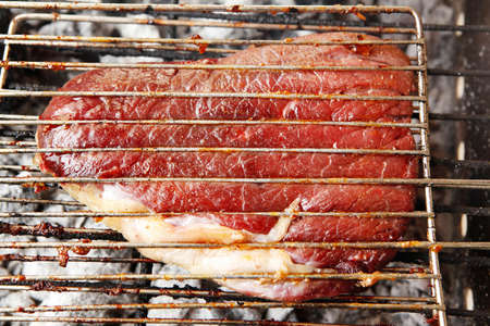 grilled roast meats beef lamb fillet ribs on bbq grid over charcoalの写真素材