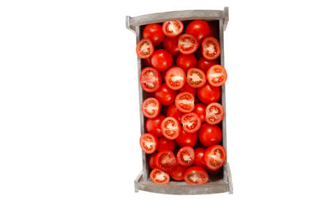 old style antique grey box full of fresh red raw tomatoes and halfs isolated over white backgroundの写真素材