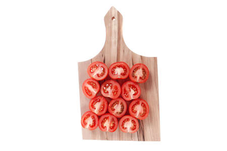 fresh raw tomatoes on light wooden plate isolated over white backgroundの写真素材