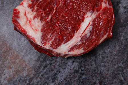 fresh raw beef meat ribeye steak on marble plateの写真素材