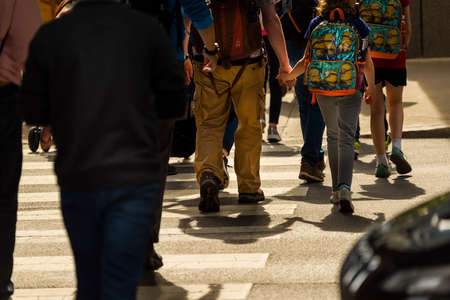 CHICAGO - May 29, 2019: Holding hands while crossing South Wabash Avenue in Chicago.のeditorial素材