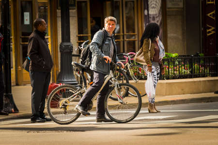 CHICAGO - May 29, 2019: A bicyclist waits to cross West Monroe Street in the Chicago Loop.のeditorial素材