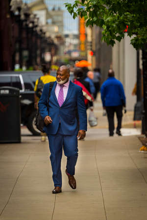 CHICAGO - May 29, 2019: A well-dressed man walks along South Wabash Avenue in Chicago.のeditorial素材