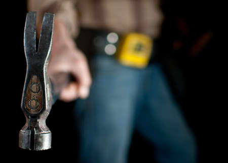 close up of a carpenter holding a hammerの写真素材