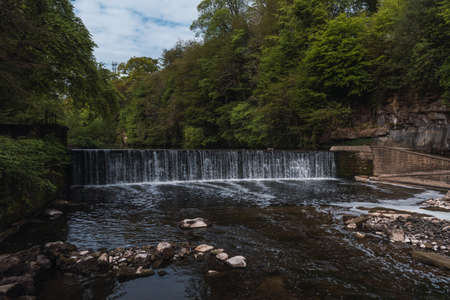 Waterfall with ligthen water in a river