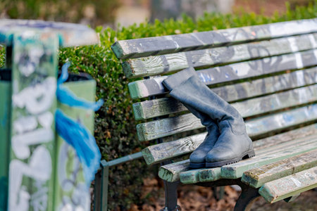 A pair of boots on a bench in the park. Close up.の写真素材
