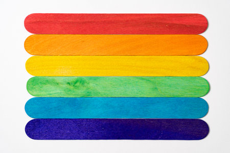 six wooden sticks with rainbow colors on white backgroundの写真素材