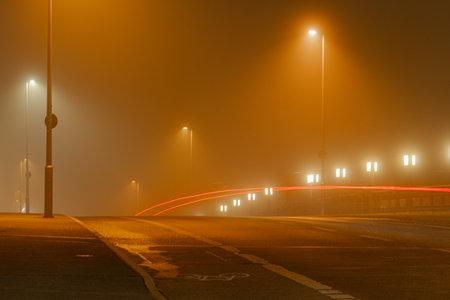 Foggy road in the city at night, long exposureの写真素材