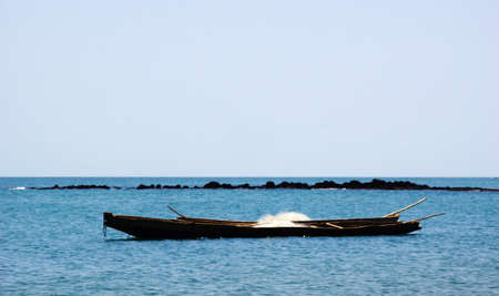 African, wooden fishing boat with nets before fishing in Gambia, West Africaの写真素材