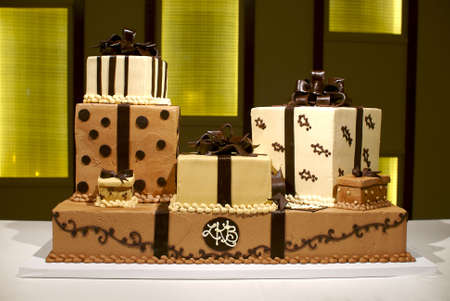 Image of a brown and white wedding cake with multiple layers, polka dots, and stripesの写真素材
