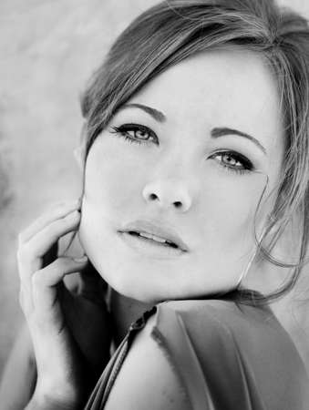 Image of a gorgeous woman with hand on her faceの写真素材