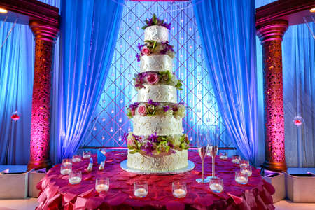 Image of a tall tiered wedding cake at Indian weddingの写真素材