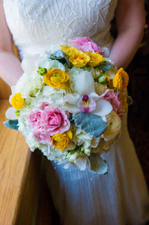 Image of a bride holding her bouquet at a weddingの写真素材