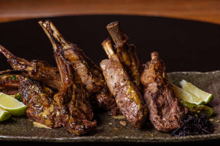 Image of freshly grilled lamb chops with lime garnishの写真素材