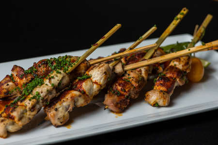 Image of freshly grilled chicken on skewersの写真素材