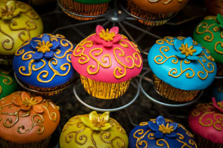Image of very colorful cupcakes on a standの写真素材