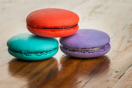 colorful macaroons on a vintage wooden tableの写真素材