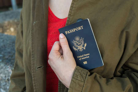 Image of a womans hand holding a passportの写真素材