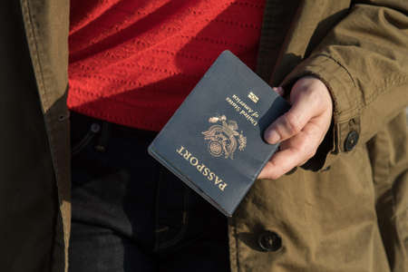 Woman holding passport in hand ready to travelの写真素材
