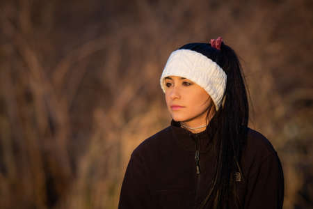 Image of a brunette girl looking out into the sunの写真素材