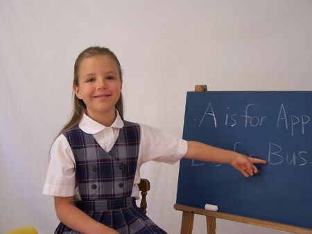 Girl pointing to chalkboard 