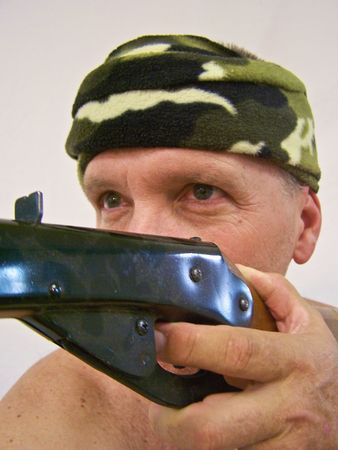 man with camouflage bandana and gun