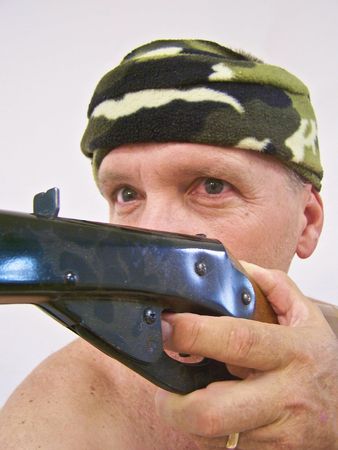 man with camouflage bandana and gun
