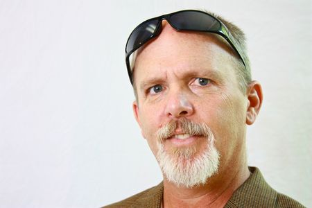 Man with sunglasses and slight smirk on his face.の写真素材