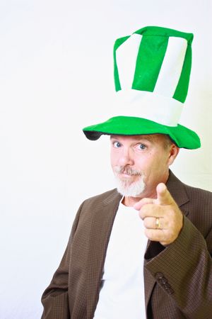 Middle aged man with tall green and white top hat pointing finger at camera.の写真素材