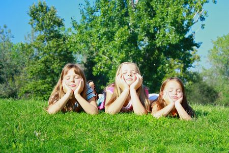 Girls lying on grassの写真素材