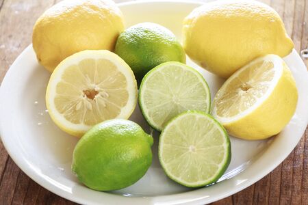Lemons and Limes on a Dishの写真素材
