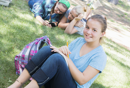 Young Girls Studying at the Parkの写真素材