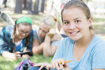 Young Girls Studying at the Parkの写真素材