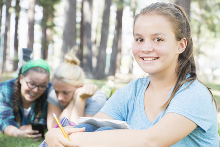 Young Girls Studying at the Parkの写真素材
