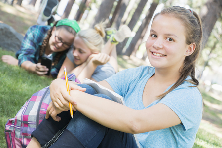 Young Girls Studying at the Parkの写真素材