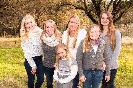 Beautiful Family of Girls Standing in Green Grassy Field