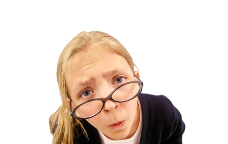 Cute Young Girl Looking Over Glasses at Cameraの写真素材